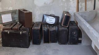 In einer der Gefängniszellen des frühen Konzentrationslagers hat der Förderverein Gedenkstätte für NS-Opfer in Neustadt Koffer aufgestellt, um an die Deportation der Juden ins Lager Gurs zu erinnern.