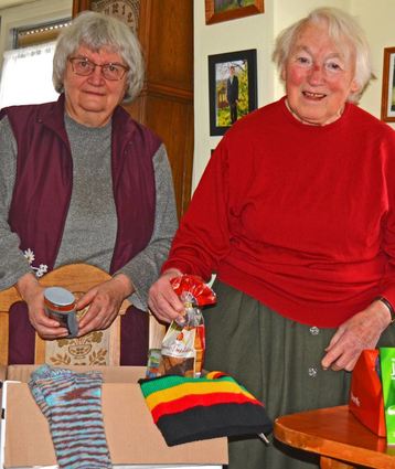 Inge Schneider (links) und Ilse Bonn sind mit weiteren Helfern dabei, die Weihnachtspäckchen für obdachlose Menschen zu packen.