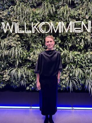 Catrin Krayer vor der grünen Willkommenswand im Loksite.