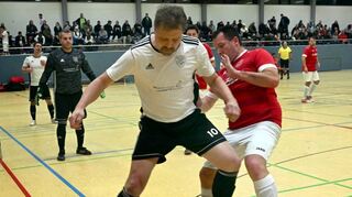 Der Schönberger Matthias Kirz (im weißen Trikot) schirmt im AH-Halbfinale den Futsal-Ball ab gegen einen Auerbacher Gegenspieler.