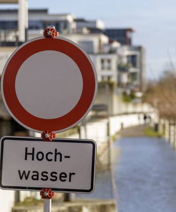 Ein Schild am Rheinufer im Wiesbadener Stadtteil Schierstein weist auf die Hochwasser-Situation hin. Das zuständige Landesamt warnt vor steigenden Pegeln in Hessen.
