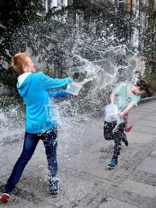 An Ostermontag begießen sich die jungen Leuten in Pawlowiczki mit Wasser aus Eimern.