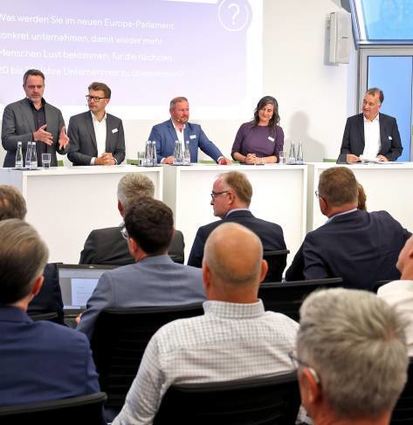 IHK-Hauptgeschäftsführer Axel Nitschke (r.) auf dem Podium.