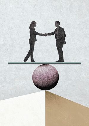 Man and woman shake hands while balanced on a seesaw.
