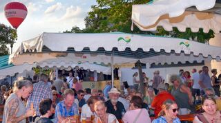 Die Besucher ließen sich Speisen und Getränke schmecken, während ein Heißluftballon lautlos über das Gelände am Hallenbad schwebte.