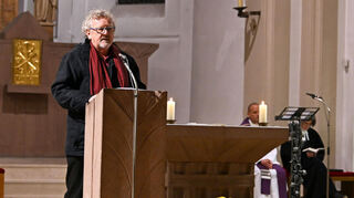 SPD-Vorsitzender Reimund Strauch spannte den Bogen vom Ersten Weltkrieg bis zum Mauerfall am 9. November 1989. Im Hintergrund Pfarrer Ludwig Siemes und Pfarrerin Beatrice Northe.